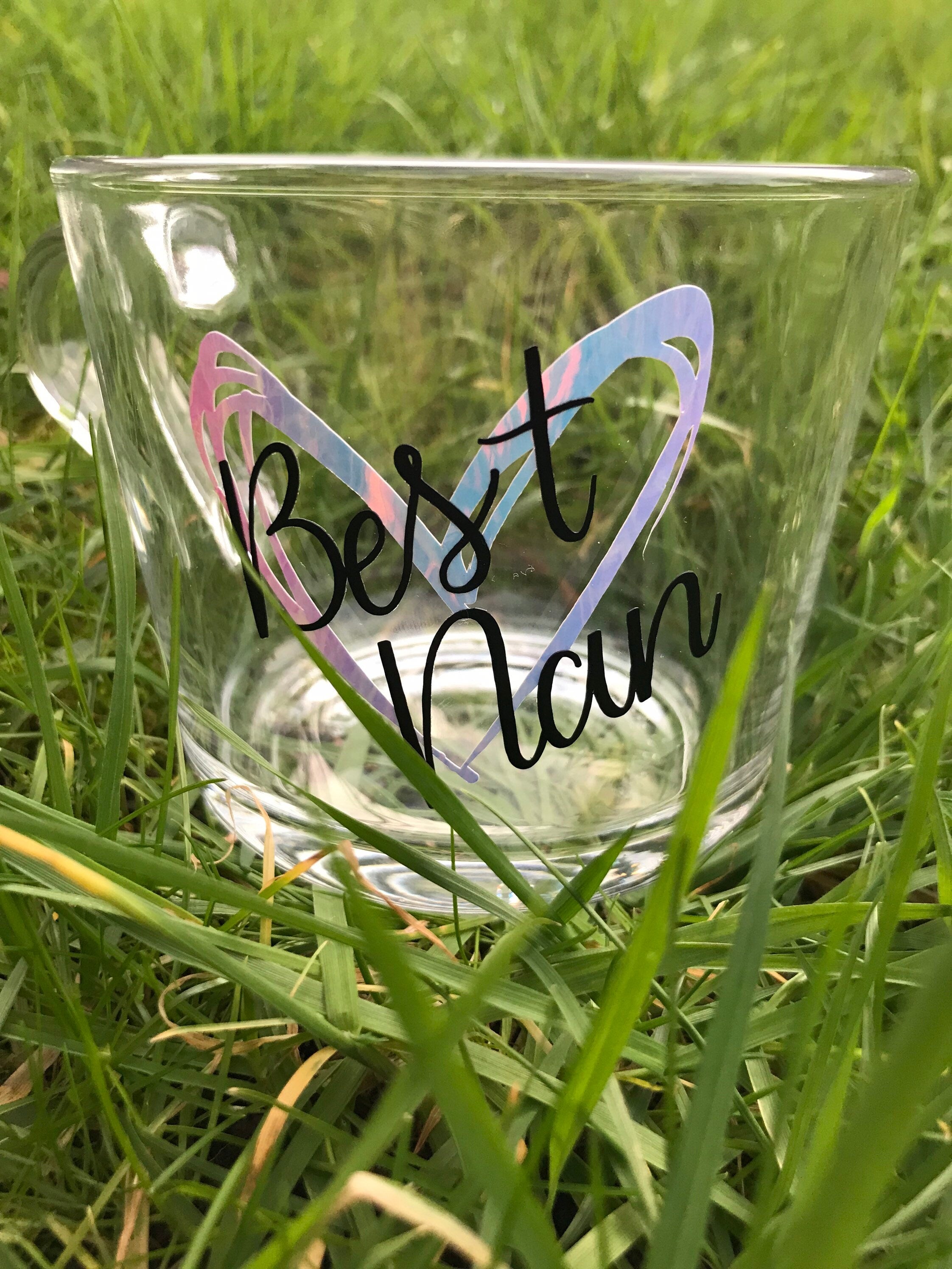 Clear glass with 'Best Man' inscription on a grass background