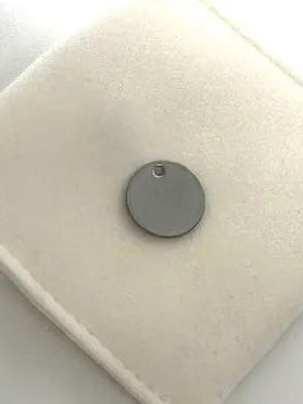 Round pendant on a velvet pouch