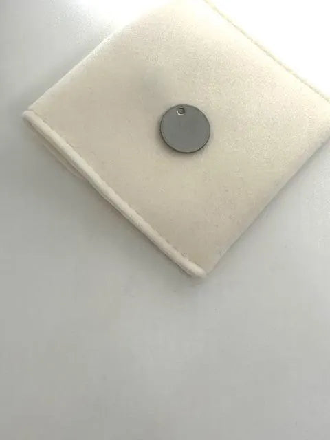 Round pendant on a velvet pouch