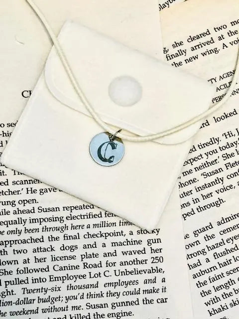 Necklace with a round pendant with initial engraved