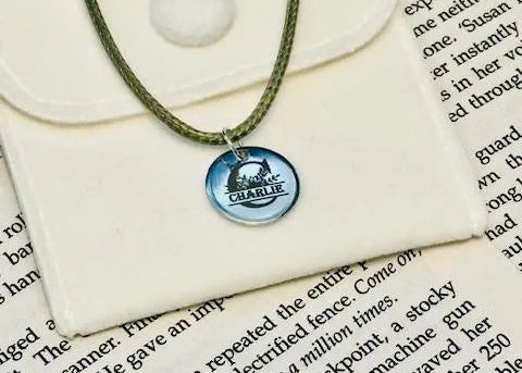 Necklace with a pendant on an open book