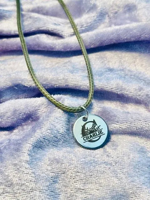 Necklace with a round pendant on a textured fabric background