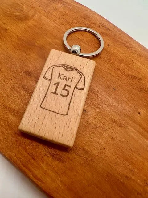 Wooden keychain with engraved football shirt design with a custom name and number