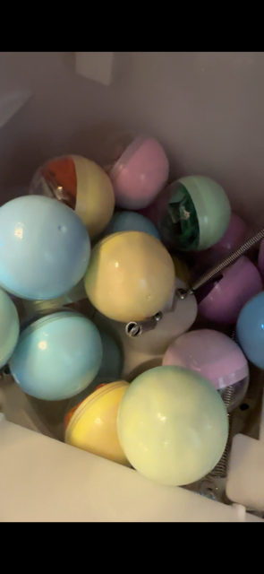 Colourful capsules filled with prizes inside a capsule vending machine