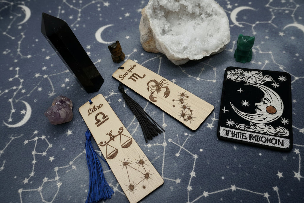 Astrology-themed bookmark including tarot cards, crystals, and zodiac symbols on a starry background.