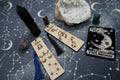 Astrology-themed bookmark including tarot cards, crystals, and zodiac symbols on a starry background.